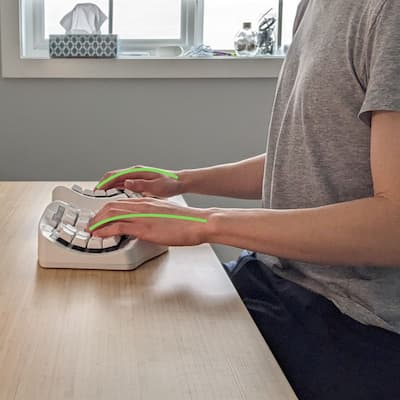 A close-up of a hand on the TAIKO-01 keyboard, fingers extended naturally.