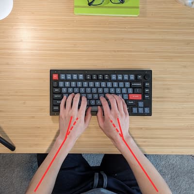 A traditional flat keyboard with wrists bent outward, demonstrating ulnar deviation.