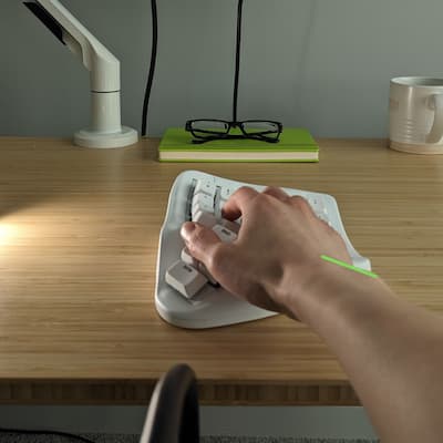 A hand on the TAIKO-01 keyboard showing reduced wrist pronation.